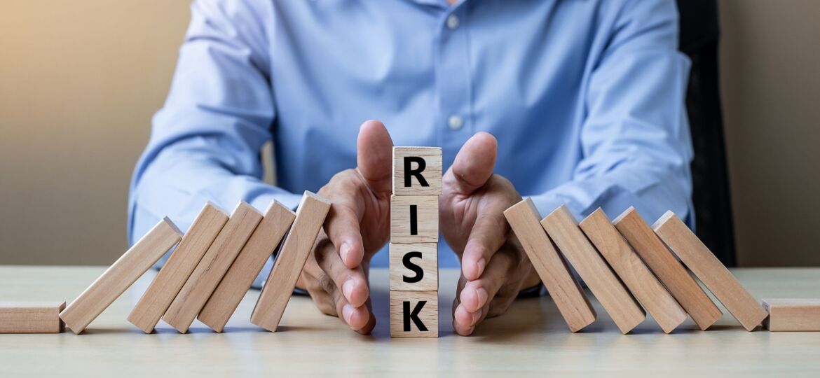 Businessman hand Stopping Falling wooden Blocks or Dominoes. Bus